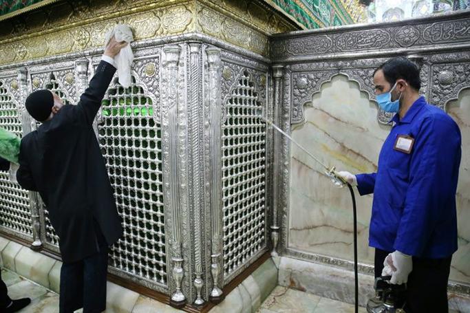 Iranian sanitary workers disinfect the revered Masumeh shrine in the Shiite holy city of Qom, which has been the epicentre of the COVID-19 outbreak in the Islamic republic (AFP Photo/MEHDI MARIZAD