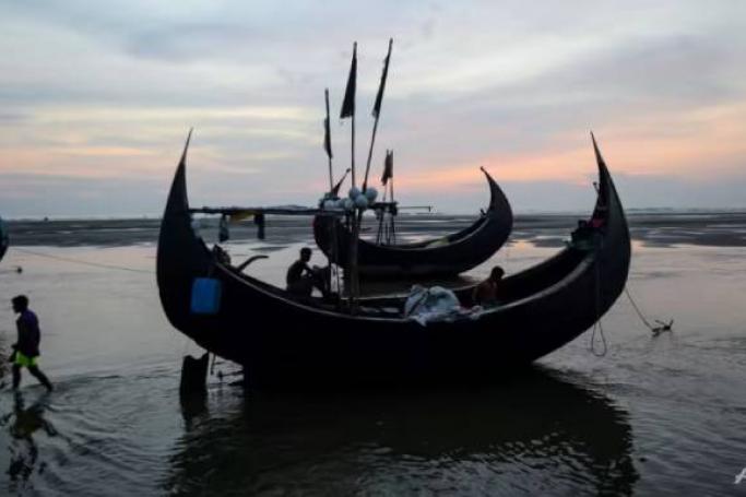 In this photograph taken on Oct 9, 2020, fishermen rest on a fishing boat at Inani beach, a boarding point of Rohingya refugees migrating to Malaysia by boat. (Photo: AFP/Munir Uz Zaman)