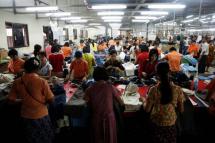 Workers tailor and arrange clothing at a garment factory at Hlaing Tar Yar industry zone in Yangon March 10, 2010.
