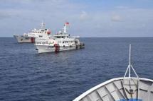 Chinese coast guard ships (left) blocking the path of a Philippine coast guard ship in the South China Sea on Aug 22. PHOTO: AFP